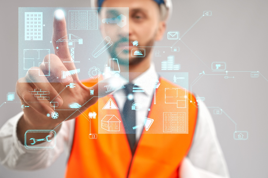 Engineer using a digital touchscreen interface with building icons to visualize smart systems and BIM integration in MEP engineering.